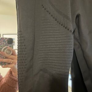 Black workout leggings with small cutouts. Size medium